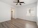 Bedroom featuring wood floors, white walls, a ceiling fan and lots of natural light at 8348 Nelson Ridge Ln, Las Vegas, NV 89178
