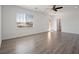 Spacious primary bedroom with hardwood floors, ceiling fan, and large windows at 8348 Nelson Ridge Ln, Las Vegas, NV 89178
