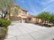 Exterior shot of home with three-car garage and spacious concrete driveway at 8348 Nelson Ridge Ln, Las Vegas, NV 89178