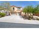 Two-story home featuring a three-car garage and desert landscaping at 8348 Nelson Ridge Ln, Las Vegas, NV 89178