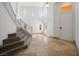 Bright foyer featuring tile flooring, high ceilings, staircase, and white front door at 8348 Nelson Ridge Ln, Las Vegas, NV 89178