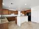 Well-lit kitchen with stainless steel appliances, granite countertops, tile flooring, and ample cabinet space at 8348 Nelson Ridge Ln, Las Vegas, NV 89178