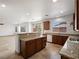 Open kitchen features granite countertops, tile flooring, gas range, and bright lighting at 8348 Nelson Ridge Ln, Las Vegas, NV 89178