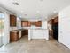 Open kitchen with wooden cabinets, granite countertops, and modern appliances at 8348 Nelson Ridge Ln, Las Vegas, NV 89178