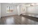 Spacious living room with hardwood floors, neutral walls, recessed lighting, and large windows at 8348 Nelson Ridge Ln, Las Vegas, NV 89178