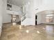 Open-concept living area with tile flooring and staircase to the second floor at 8348 Nelson Ridge Ln, Las Vegas, NV 89178