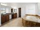 Main bathroom featuring dual sinks, a soaking tub, and a walk-in closet at 8348 Nelson Ridge Ln, Las Vegas, NV 89178