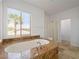Main bathroom featuring a large soaking tub and glass shower at 8348 Nelson Ridge Ln, Las Vegas, NV 89178