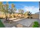 Private backyard featuring a paver patio, gravel landscaping, and mature trees at 10172 Bismarck Palms Ave, Las Vegas, NV 89166