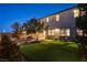 Expansive backyard with artificial lawn, desert landscaping, patio dining, and bench seating, ideal for entertaining at 10172 Bismarck Palms Ave, Las Vegas, NV 89166