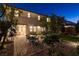 The backyard includes a patio area with dining, desert landscaping, and well maintained artificial grass at 10172 Bismarck Palms Ave, Las Vegas, NV 89166