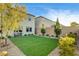 Landscaped backyard with artificial turf, rock ground cover, and privacy wall at 10172 Bismarck Palms Ave, Las Vegas, NV 89166
