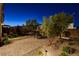 The backyard has a spacious patio, desert landscaping, and artificial grass for a serene outdoor experience at 10172 Bismarck Palms Ave, Las Vegas, NV 89166