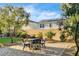 Beautiful backyard with lush greenery, a paver patio, and privacy wall at 10172 Bismarck Palms Ave, Las Vegas, NV 89166