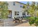 Charming backyard with a dining set, landscaping, and a well-maintained lawn at 10172 Bismarck Palms Ave, Las Vegas, NV 89166