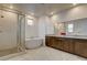Bright bathroom featuring a soaking tub, glass-enclosed shower and a double vanity at 10172 Bismarck Palms Ave, Las Vegas, NV 89166