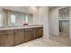 Bathroom featuring a double vanity with quartz countertops, large mirror and modern fixtures at 10172 Bismarck Palms Ave, Las Vegas, NV 89166