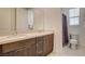 Bathroom featuring dual sinks, quartz countertops, and a separate toilet and shower area at 10172 Bismarck Palms Ave, Las Vegas, NV 89166
