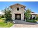 Clubhouse featuring a stone facade, inviting entryway, and lush landscaping for a welcoming atmosphere at 10172 Bismarck Palms Ave, Las Vegas, NV 89166