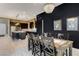 Open-concept kitchen and dining area with modern island seating and stainless steel appliances at 10172 Bismarck Palms Ave, Las Vegas, NV 89166