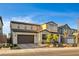 Home exterior with brick driveway, a two-car garage, and desert landscaping at 10172 Bismarck Palms Ave, Las Vegas, NV 89166