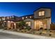 Charming two-story home boasting manicured landscaping, complemented by a well-lit exterior and inviting entryway at 10172 Bismarck Palms Ave, Las Vegas, NV 89166