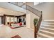 Welcoming foyer with stairs, a view into the living room, and sleek design at 10172 Bismarck Palms Ave, Las Vegas, NV 89166