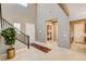 Light-filled foyer with staircase, plant, and open floor plan at 10172 Bismarck Palms Ave, Las Vegas, NV 89166