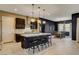 Modern kitchen with an island, stainless steel appliances, and stylish bar stool seating at 10172 Bismarck Palms Ave, Las Vegas, NV 89166