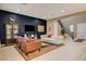 Spacious living room with dark accent wall, plush seating, and staircase access to the upper level at 10172 Bismarck Palms Ave, Las Vegas, NV 89166