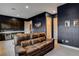 Cozy living room features a brown leather couch and modern cabinets with a mini fridge at 10172 Bismarck Palms Ave, Las Vegas, NV 89166
