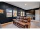 Comfortable living room boasts a leather sofa, stylish cabinets, and view from windows at 10172 Bismarck Palms Ave, Las Vegas, NV 89166