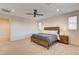 Bright main bedroom with a ceiling fan, natural light, neutral walls and cozy carpet at 10172 Bismarck Palms Ave, Las Vegas, NV 89166