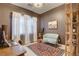 Bright home office with a comfortable seating area, a work desk, and a window with natural light at 10172 Bismarck Palms Ave, Las Vegas, NV 89166