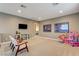 Spacious play room with comfy seating, a TV, and toys at 10172 Bismarck Palms Ave, Las Vegas, NV 89166