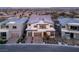 Stunning aerial view of a modern home showcasing its landscaped yard, three-car garage, and prime neighborhood location at 10655 Patina Hills Ct, Las Vegas, NV 89135