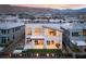 Aerial view of a modern backyard, featuring a covered patio and lush lawn, with mountain views at 10655 Patina Hills Ct, Las Vegas, NV 89135
