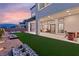 Well-designed backyard features artificial turf, patio, and professional landscaping for year-round enjoyment at 10655 Patina Hills Ct, Las Vegas, NV 89135