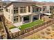 This stunning home includes a covered patio, manicured lawn, and mountain views at 10655 Patina Hills Ct, Las Vegas, NV 89135