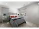 Well-lit bedroom with grey decor, a comfortable bed, and large windows at 10655 Patina Hills Ct, Las Vegas, NV 89135