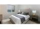 Comfortable bedroom with tufted headboard, neutral colors, and side tables with lamps at 10655 Patina Hills Ct, Las Vegas, NV 89135