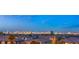 Expansive cityscape view of Las Vegas skyline and residential rooftops at twilight at 10655 Patina Hills Ct, Las Vegas, NV 89135