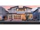 Contemporary two-story home boasts a well-manicured yard, brick driveway, and a three-car garage at 10655 Patina Hills Ct, Las Vegas, NV 89135