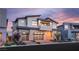 Stunning two-story home features a modern design, stone accents, a two-car garage and manicured landscaping at 10655 Patina Hills Ct, Las Vegas, NV 89135