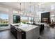 Open-concept kitchen featuring a large island, high ceilings, and seamless access to the outdoor space at 10655 Patina Hills Ct, Las Vegas, NV 89135