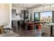 Contemporary kitchen with stainless steel appliances, island seating, and sliding glass doors to the backyard at 10655 Patina Hills Ct, Las Vegas, NV 89135