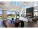Bright, open living room with floor-to-ceiling windows, fireplace, and access to a landscaped backyard at 10655 Patina Hills Ct, Las Vegas, NV 89135