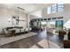 Bright living space with soaring ceilings, a dining area, and seamless indoor-outdoor flow to the backyard at 10655 Patina Hills Ct, Las Vegas, NV 89135