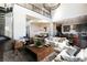 Open-concept living area showcasing modern finishes, a staircase, and a seamless flow into the dining and kitchen spaces at 10655 Patina Hills Ct, Las Vegas, NV 89135
