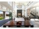 Expansive living room with soaring ceilings, a sleek fireplace, and a staircase leading to the second floor at 10655 Patina Hills Ct, Las Vegas, NV 89135